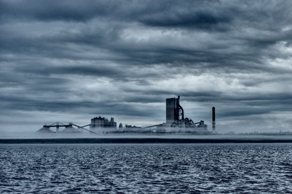 Cement factory wrapped in erie fog bank